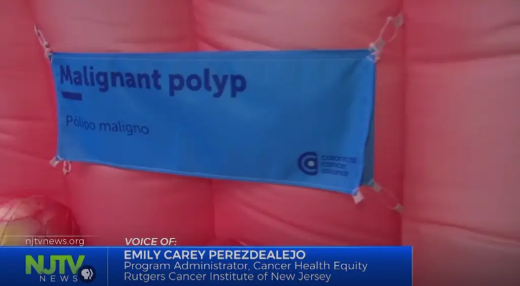 Screen capture of NJTV video featuring image of inflatable colon with text "malignant polyp."