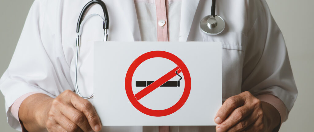 Quit smoking, no tobacco day, doctor holding no smoking sign