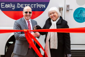 Steven K. Libutti, MD, FACS, (left) and Anita Kinney, PhD, RN, FAAN, FABMR, cut the ribbon to officially "open" the Lifesaver.